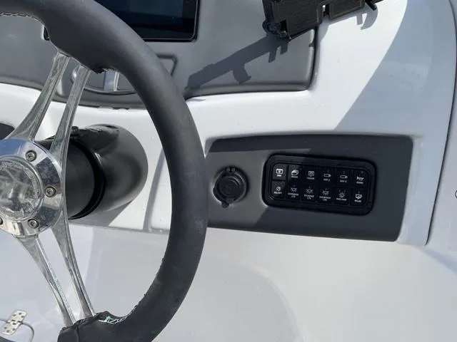 Slide: The Image of Steering wheel and control panel of 2024 Tahoe 210 S boat. - 37