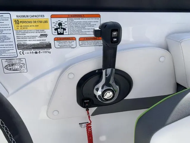 Slide: The Image of 2024 Tahoe 210 S boat throttle control with capacity and warning labels. - 38