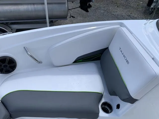 Slide: The Image of 2024 Tahoe 210 S boat interior with gray and white seating, green accents, and speaker. - 42