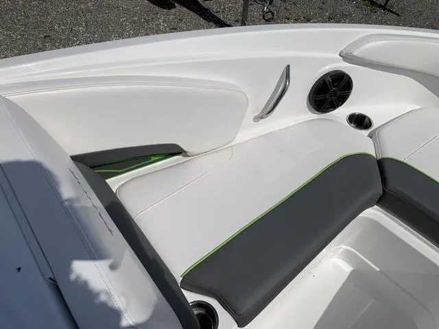 Slide: The Image of 2024 Tahoe 210 S boat interior with white and gray seating, green accents, and speaker. - 45
