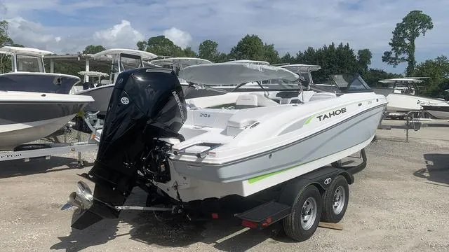 Slide: The Image of 2024 Tahoe 210 S boat on trailer, parked outdoors. - 5