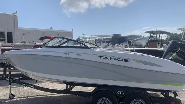 Slide: The Image of 2024 Tahoe 210 S boat on trailer in marina setting. - 8