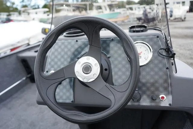 Slide: The Image of 2025 Tracker CLASSIC XL boat dashboard with steering wheel and gauge. - 10
