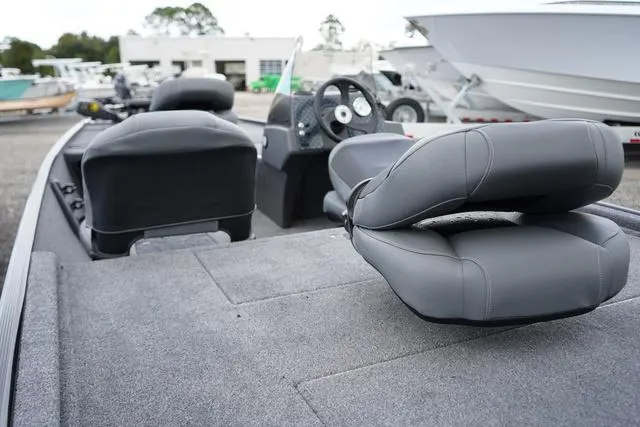 Slide: The Image of 2025 Tracker CLASSIC XL boat interior with gray seating and steering wheel. - 5