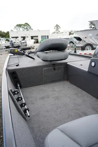 Slide: The Image of 2025 Tracker CLASSIC XL boat interior with seating and fishing rod holders. - 6