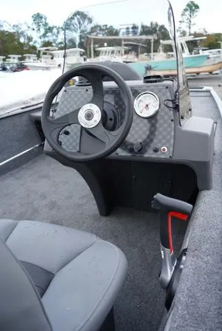 Slide: The Image of 2025 Tracker CLASSIC XL boat interior with steering wheel and dashboard controls. - 9