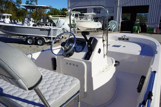 Slide: The Image of 2025 Carolina Skiff 178 JLS boat interior with steering console and seating. - 11
