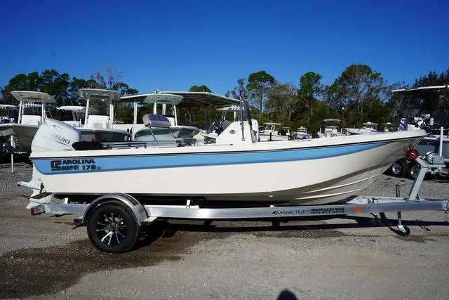 Slide: The Image of 2025 Carolina Skiff 178 JLS boat on trailer, parked outdoors. - 2