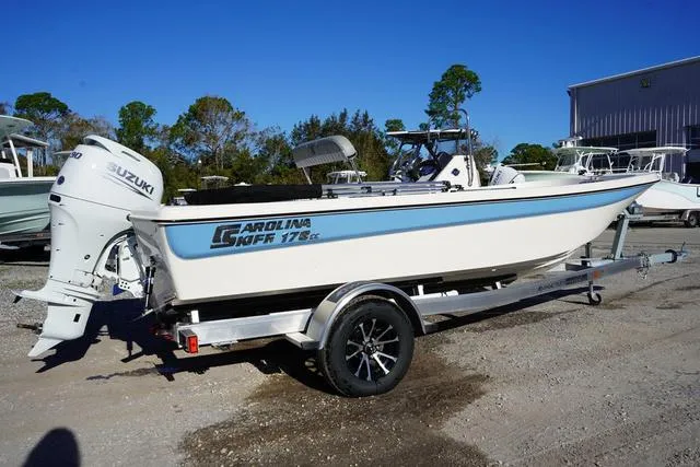 Slide: The Image of 2025 Carolina Skiff 178 JLS boat on trailer with Suzuki outboard motor. - 3