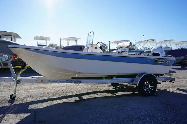 Slide: The Image of 2025 Carolina Skiff 178 JLS boat on trailer under clear blue sky. - 6