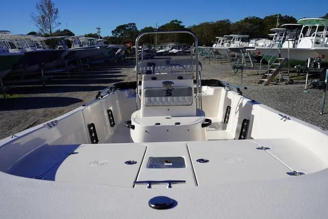 Slide: The Image of 2025 Carolina Skiff 178 JLS boat in a marina, showcasing interior and seating. - 7