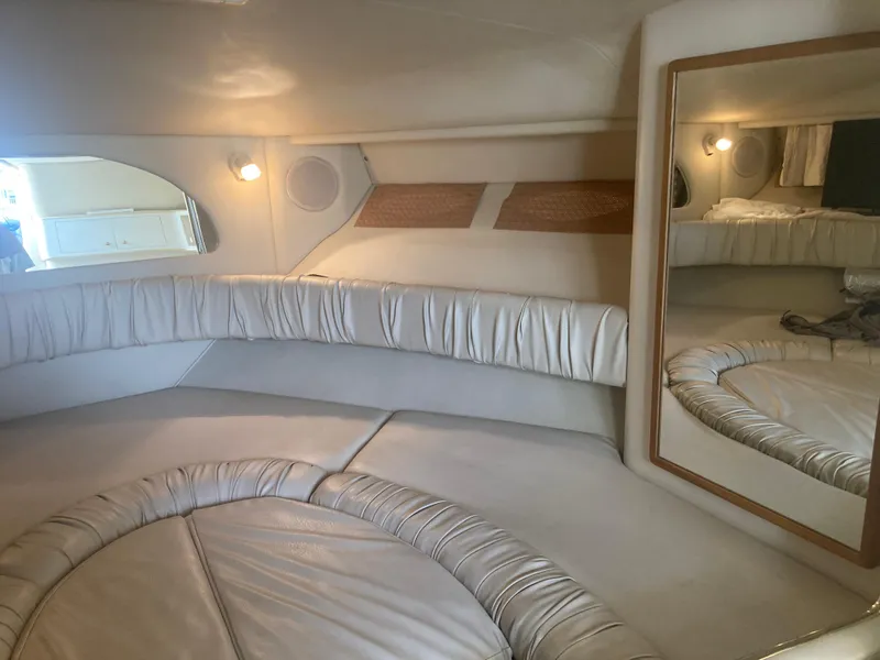 Slide: The Image of Interior of 1999 Sea Ray 330 Express Cruiser with plush seating and mirror. - 11