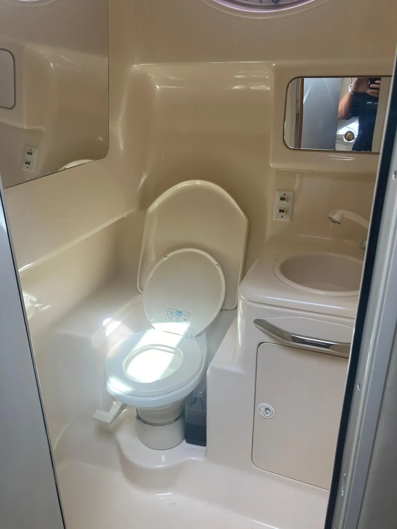 Slide: The Image of 1999 Sea Ray 330 Express Cruiser bathroom with toilet and sink. - 20