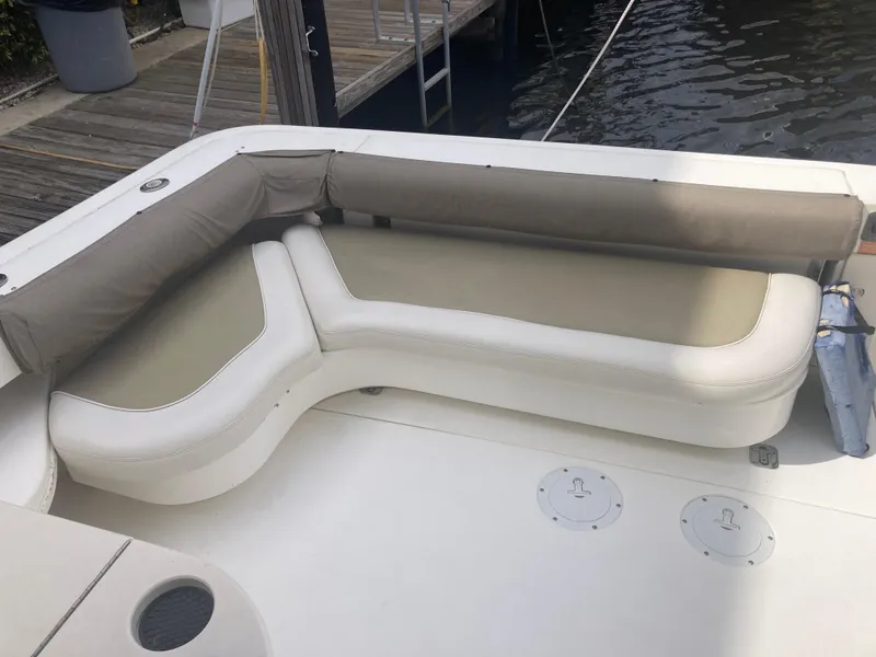 Slide: The Image of 1999 Sea Ray 330 Express Cruiser with beige seating on deck. - 22