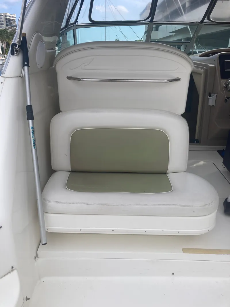 Slide: The Image of 1999 Sea Ray 330 Express Cruiser interior seating with white and green upholstery. - 23