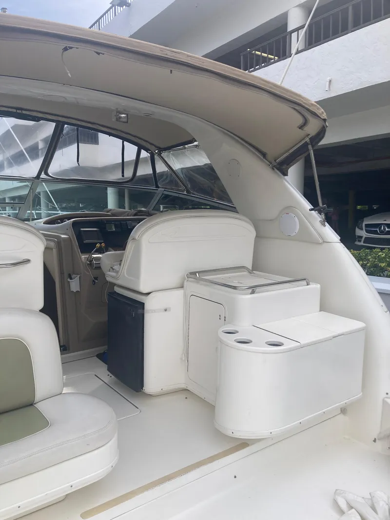 Slide: The Image of 1999 Sea Ray 330 Express Cruiser interior with seating and helm. - 25
