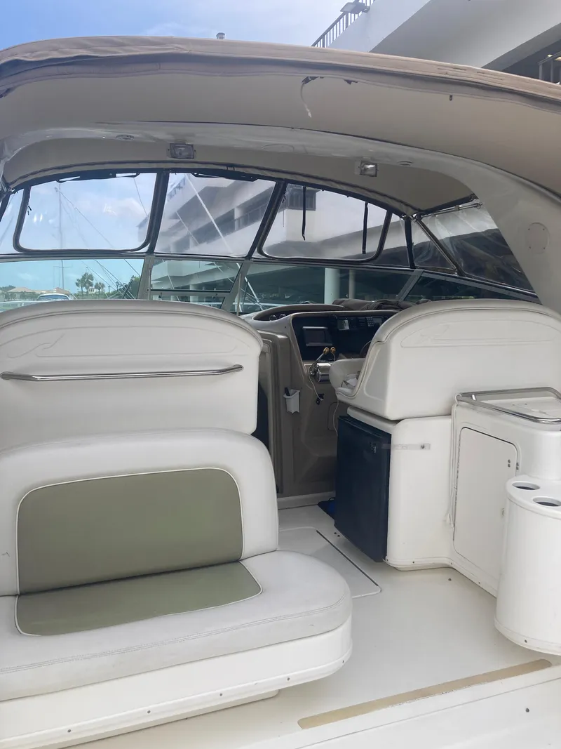 Slide: The Image of 1999 Sea Ray 330 Express Cruiser interior with seating and helm. - 26
