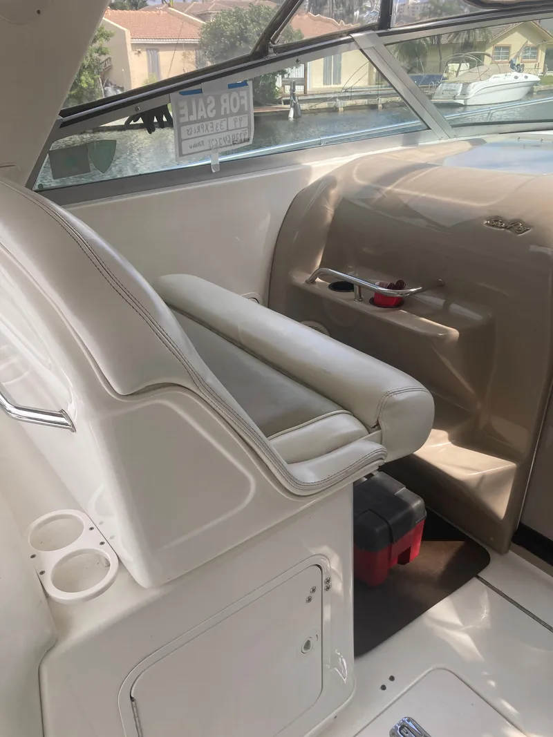Slide: The Image of 1999 Sea Ray 330 Express Cruiser interior with helm seat and dashboard. - 27