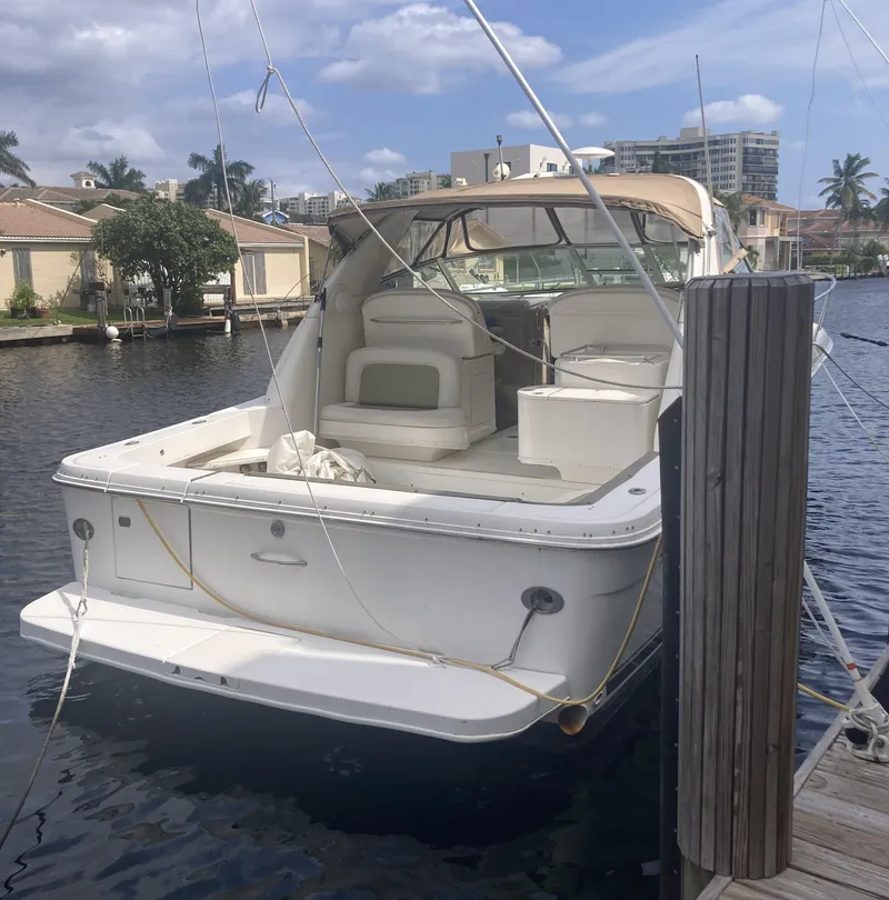 Slide: The Image of 1999 Sea Ray 330 Express Cruiser docked in a marina, sunny day. - 6