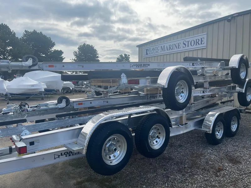 Slide: The Image of 2025 Load Rite 5s-AC23T5200 boat trailers stacked at marine store. - 6