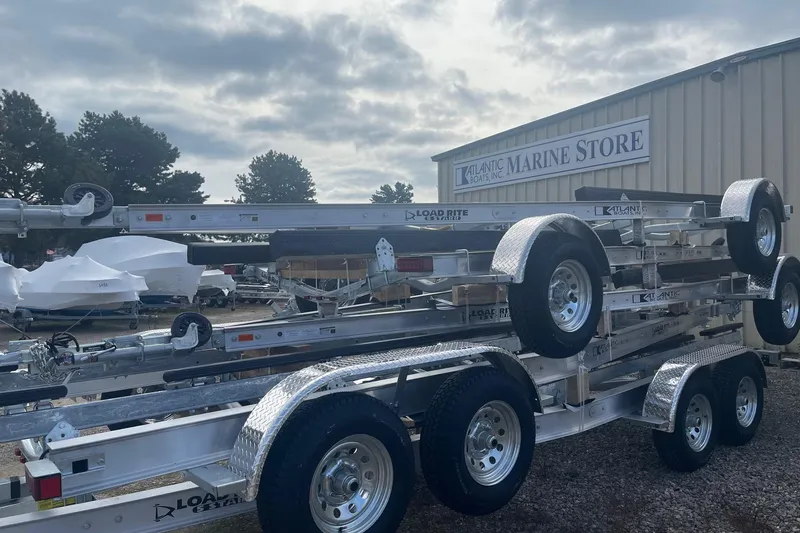 Slide: The Image of 2025 Load Rite 5s-AC23T5200 boat trailers stacked at marine store. - 8