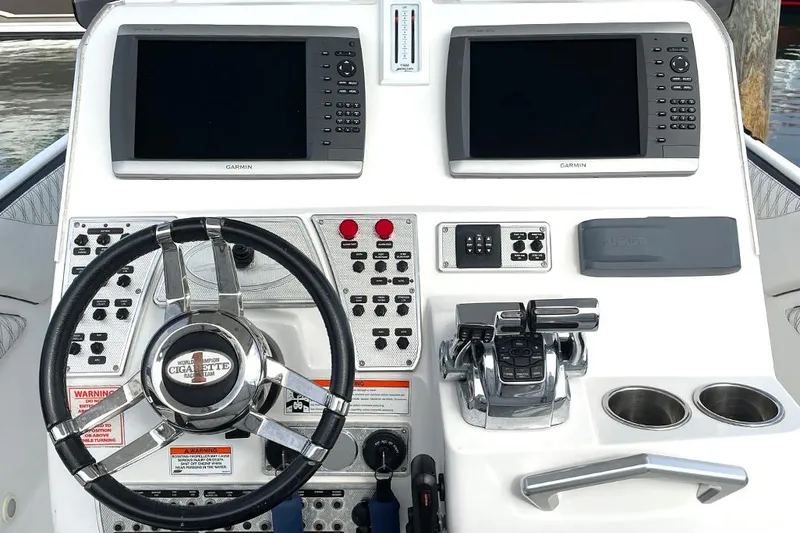 Slide: The Image of 2013 Cigarette 39 Top Gun Open dashboard with dual Garmin displays and controls. - 10