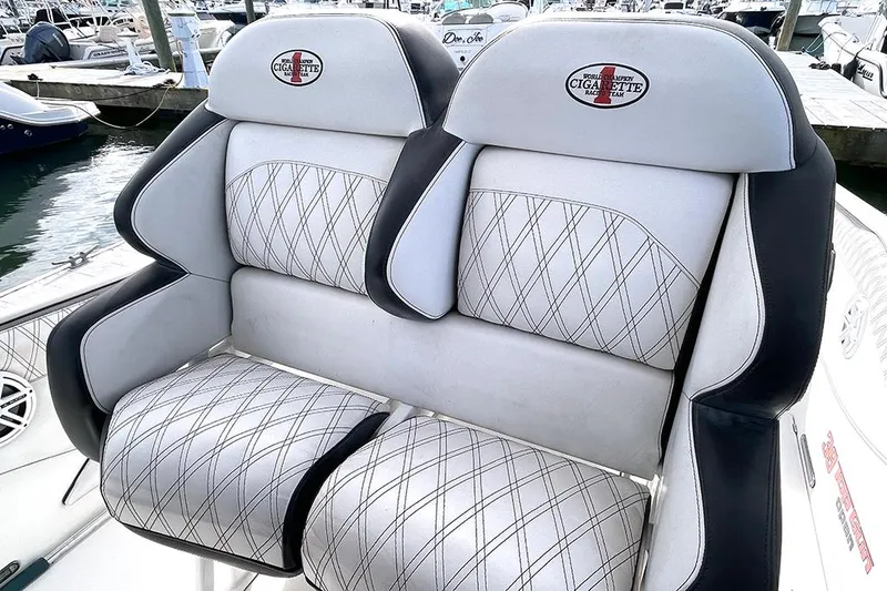 Slide: The Image of 2013 Cigarette 39 Top Gun Open boat seats with diamond stitching at marina. - 11