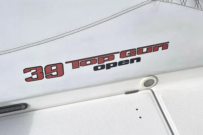 Slide: The Image of 2013 Cigarette 39 Top Gun Open boat logo on white surface. - 12