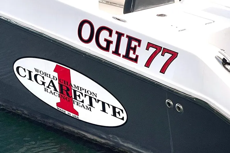 Slide: The Image of 2013 Cigarette 39 Top Gun Open boat with "OGIE 77" and racing team logo. - 13