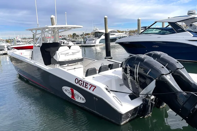 Slide: The Image of 2013 Cigarette 39 Top Gun Open boat docked in marina with twin engines. - 2