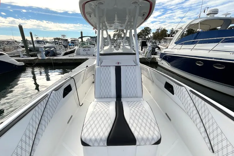 Slide: The Image of 2013 Cigarette 39 Top Gun Open boat interior at marina, featuring sleek seating and modern design. - 7