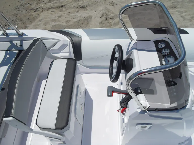 Slide: The Image of 2025 Ranieri CAYMAN 19 Sport boat interior with steering console and seating. - 10