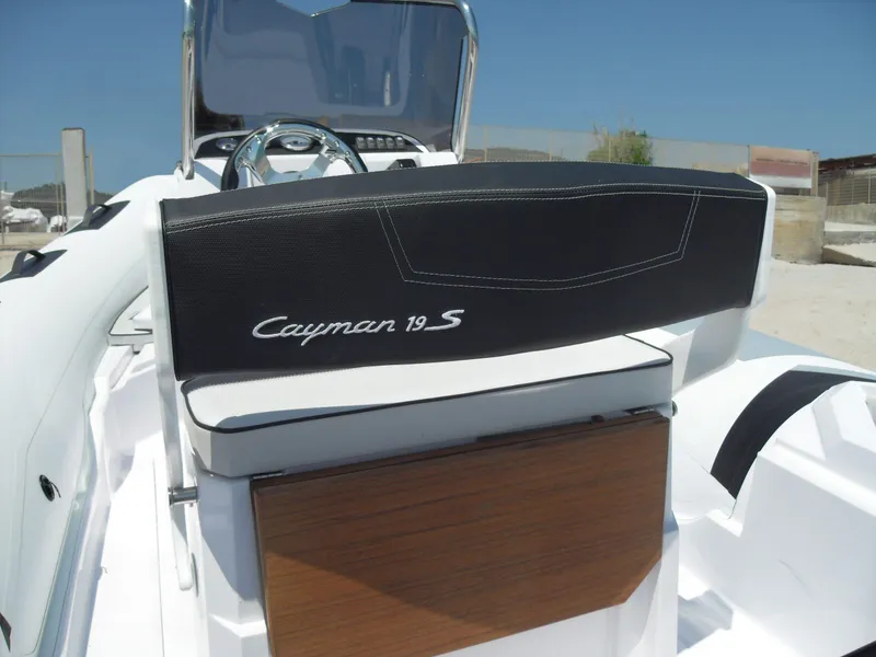 Slide: The Image of 2025 Ranieri CAYMAN 19 Sport boat interior with steering wheel and seating. - 8