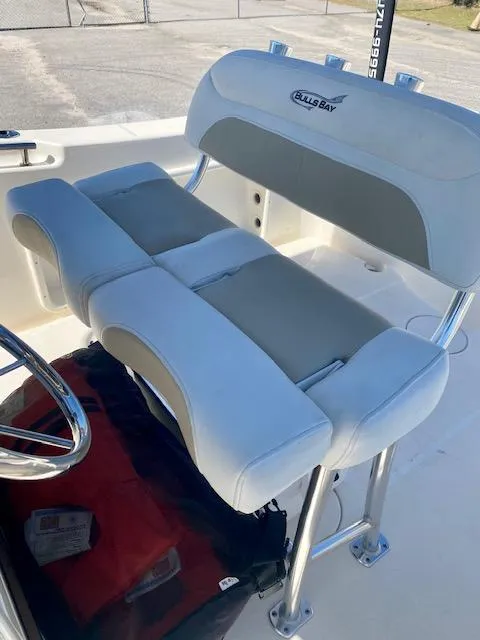 Slide: The Image of 2022 Bulls Bay 230 Center Console boat seat with white and gray upholstery. - 14