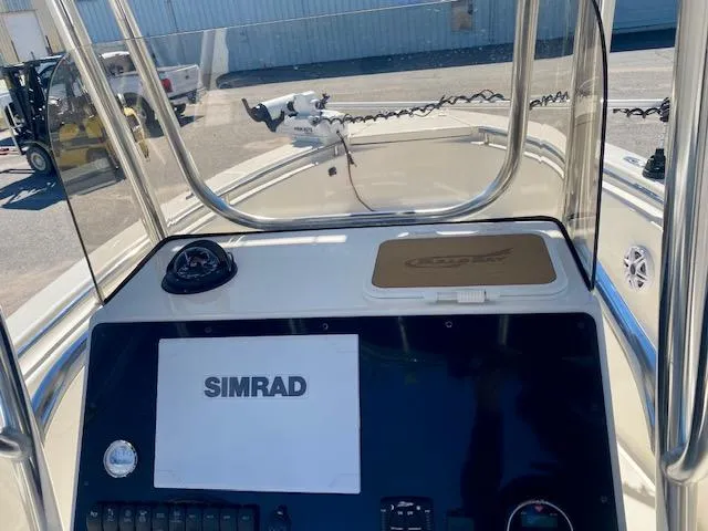 Slide: The Image of 2022 Bulls Bay 230 Center Console boat dashboard with Simrad navigation system. - 16