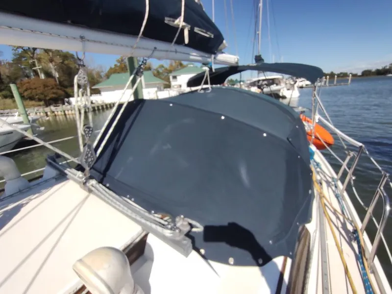 Slide: The Image of Sailboat Catalina C-34, 1990 model, docked with blue canvas cover, sunny day. - 13