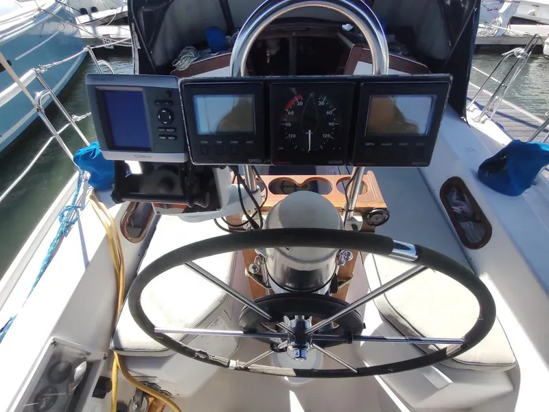 Slide: The Image of Cockpit of a 1990 Catalina C-34 sailboat with navigation instruments and steering wheel. - 17