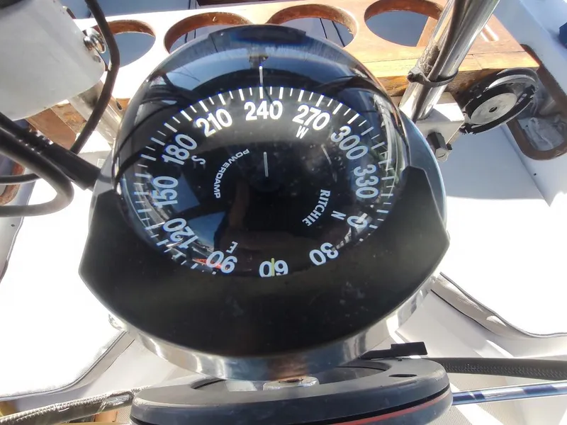 Slide: The Image of Compass on a 1990 Catalina C-34 sailboat, showing navigation directions. - 18