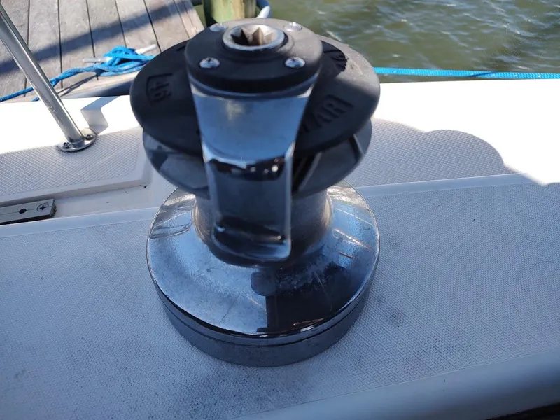 Slide: The Image of Winch on a 1990 Catalina C-34 sailboat deck, near water and dock. - 25