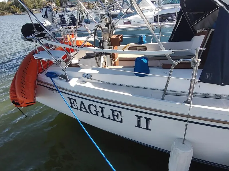 Slide: The Image of Catalina C-34 sailboat "Eagle II" docked, featuring lifebuoy and nautical equipment. - 3