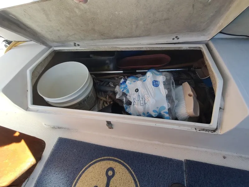 Slide: The Image of Storage compartment on 1990 Catalina C-34 sailboat with supplies and cleaning tools. - 30