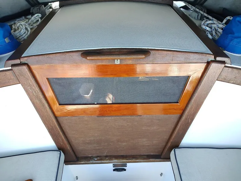 Slide: The Image of 1990 Catalina C-34 sailboat cabin entrance with wooden hatch and nautical ropes. - 31