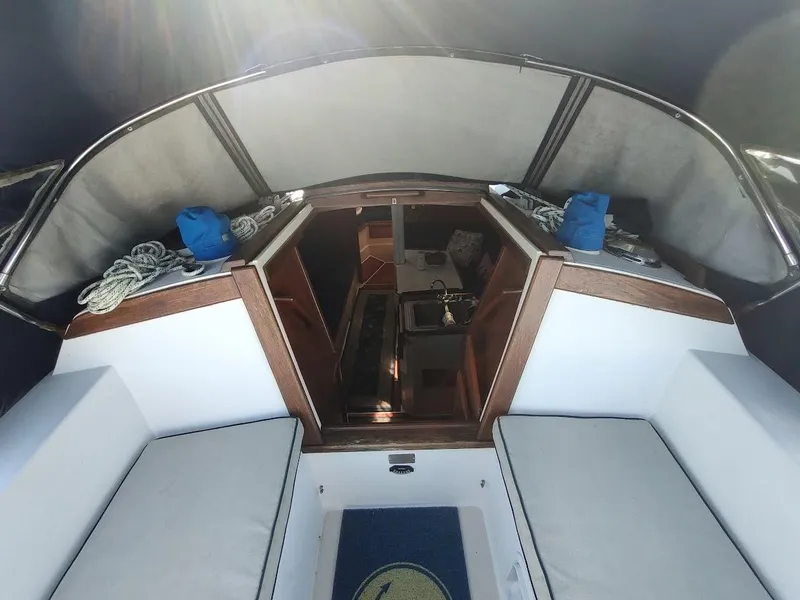 Slide: The Image of Interior view of a 1990 Catalina C-34 sailboat cockpit with seating and cabin entrance. - 32