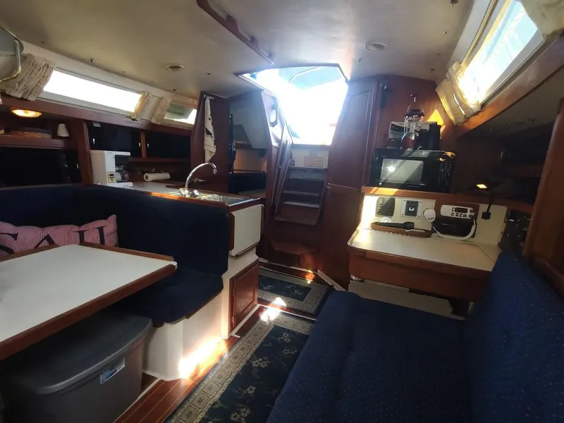 Slide: The Image of Interior of 1990 Catalina C-34 sailboat with cozy seating and kitchen area. - 34