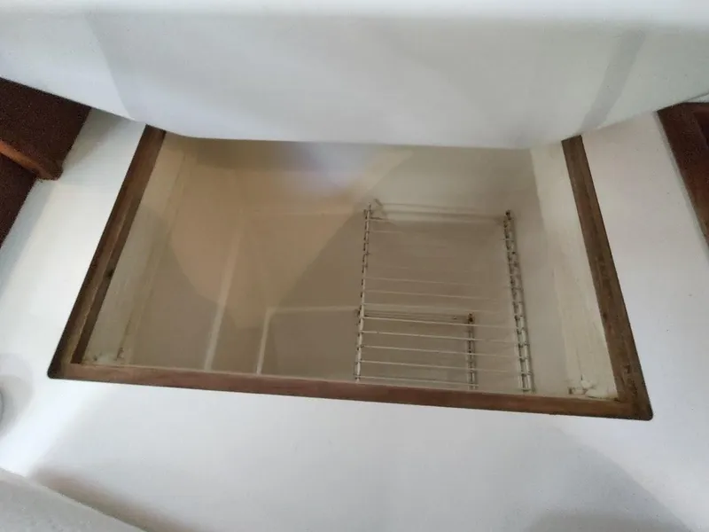 Slide: The Image of Empty storage compartment in a 1990 Catalina C-34 sailboat interior. - 39