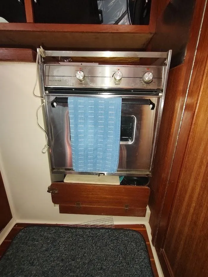 Slide: The Image of Stainless steel oven with blue towel in 1990 Catalina C-34 yacht kitchen. - 42
