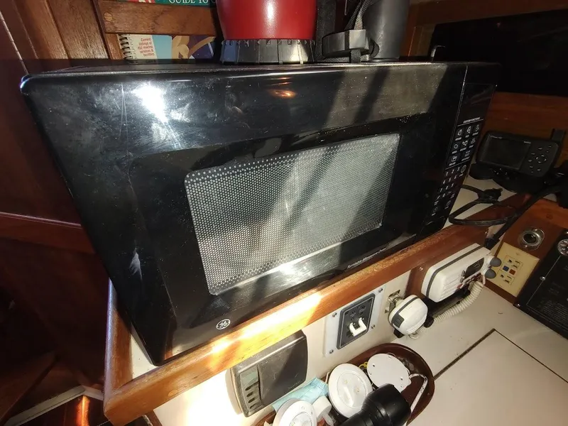Slide: The Image of Microwave inside a 1990 Catalina C-34 sailboat kitchen area. - 44
