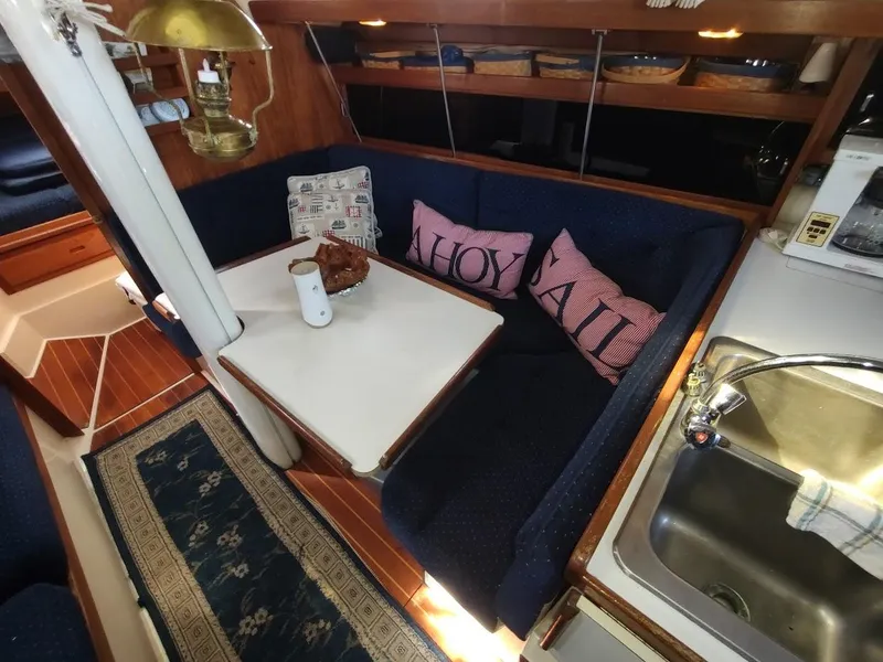 Slide: The Image of Cozy interior of 1990 Catalina C-34 sailboat with dining area and kitchen sink. - 46