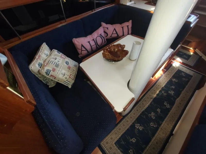 Slide: The Image of Interior of 1990 Catalina C-34 sailboat with cozy seating and nautical-themed pillows. - 47