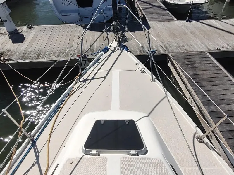 Slide: The Image of Bow view of a 1990 Catalina C-34 sailboat docked at a marina. - 7